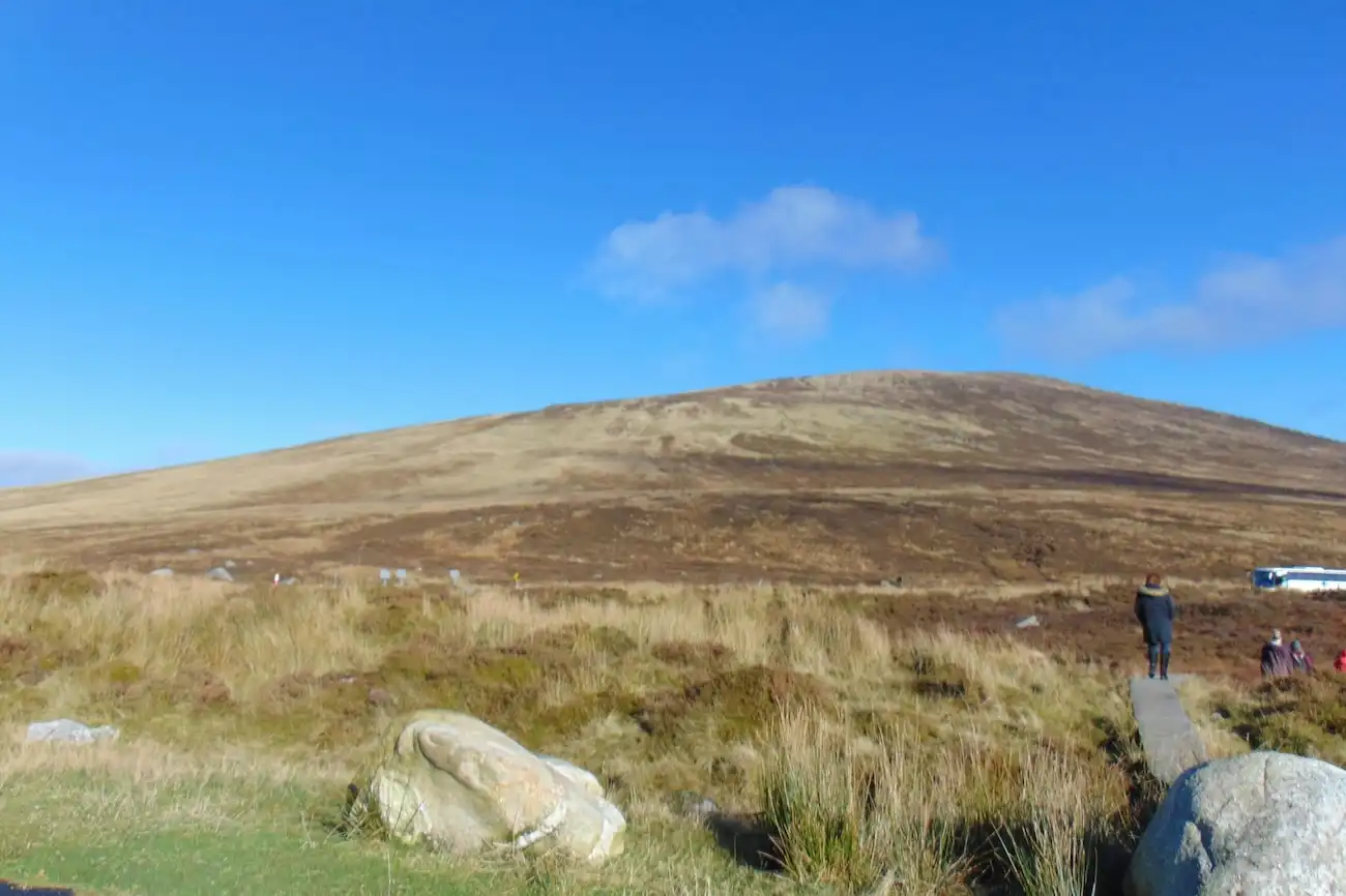 A person walking along a path in the scenic Wicklow Mountains.